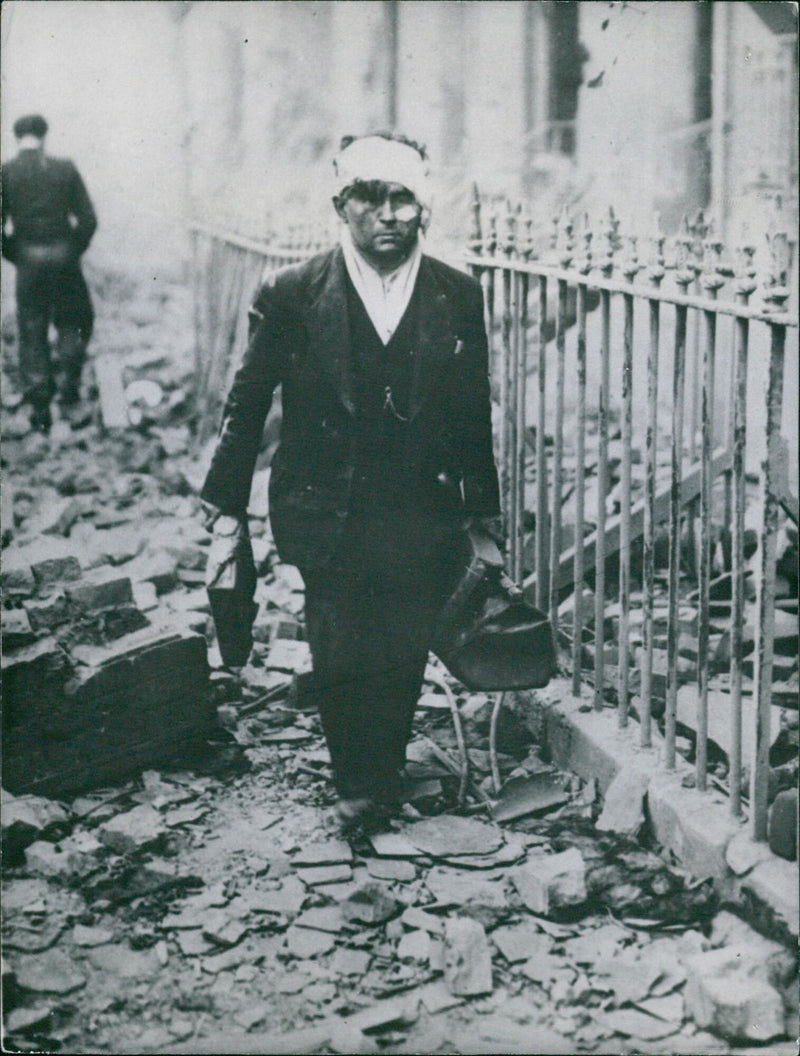 In this 1940 photo, citizens of London, England, survey the damage caused by war. The photo was taken by Me 71 Do SU of Åhlén & Åkerlunds Bild-Arkiv. - Vintage Photograph