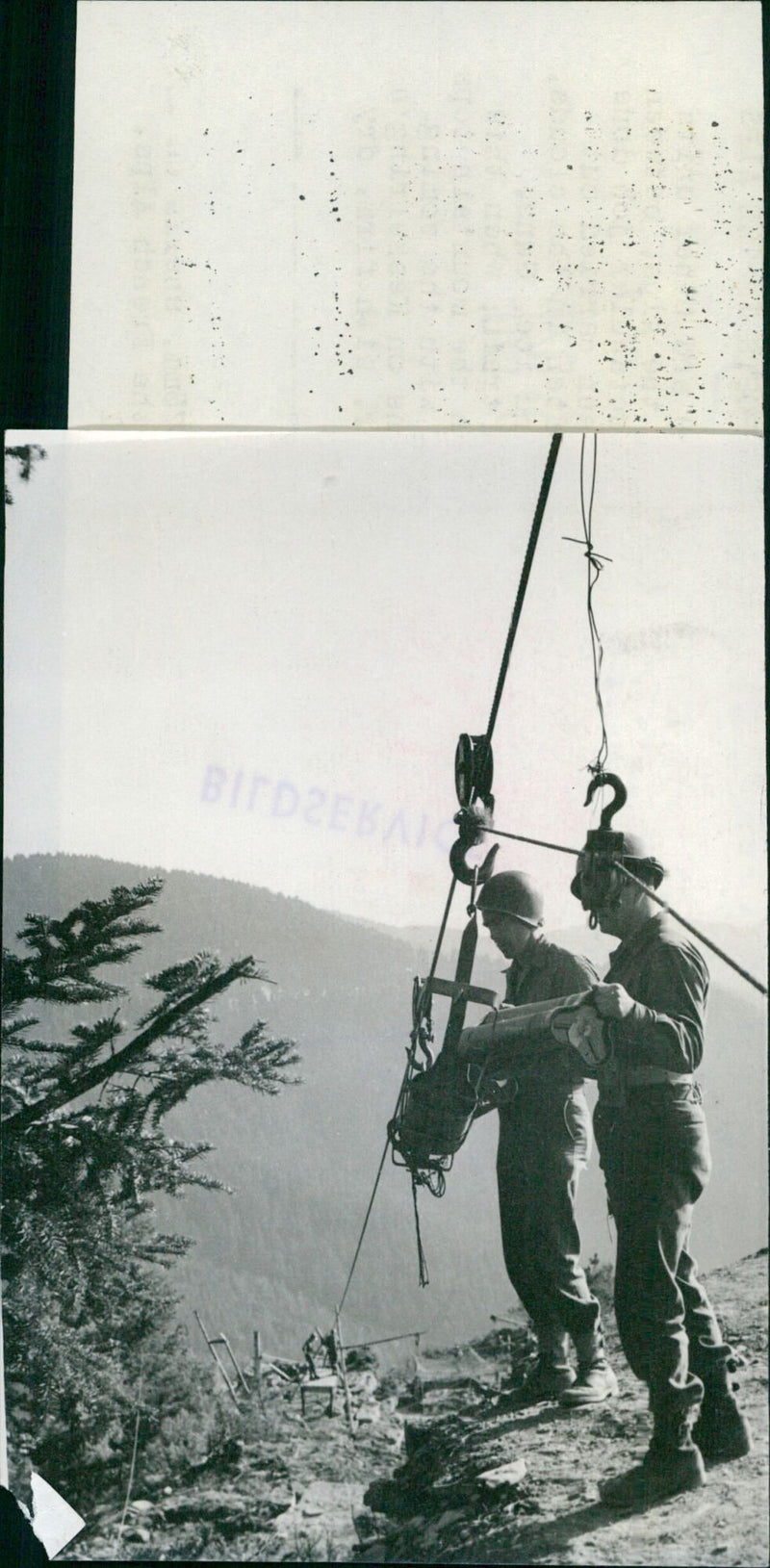 American troops of the 44th Brigade load shells for a howitzer emplacement in the French Alps. - Vintage Photograph