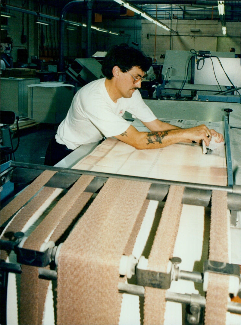 Brian Ling operating a folding machine at a Nuffield Press facility in Oxford, UK. - Vintage Photograph