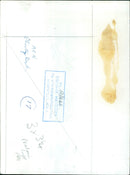 A woman applies cream to her hair at a beauty salon. - Vintage Photograph