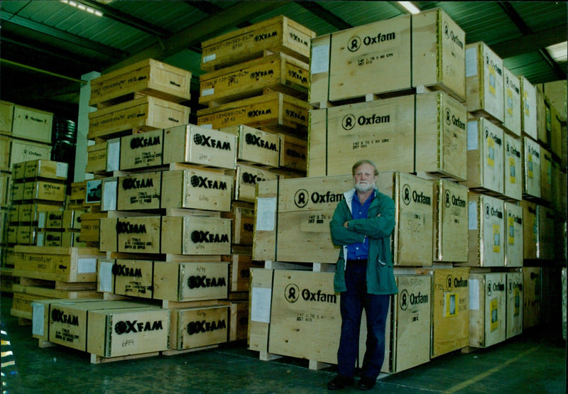 Teri Scully and Diana Gibson compare products from the Oxfam Trade Company's emergency store warehouse. - Vintage Photograph