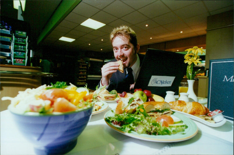 Matthew Weekes samples the lunchtime selection at the new Eurest Sutcliffe staff restaurant in ACNielsen's Oxford offices. - Vintage Photograph