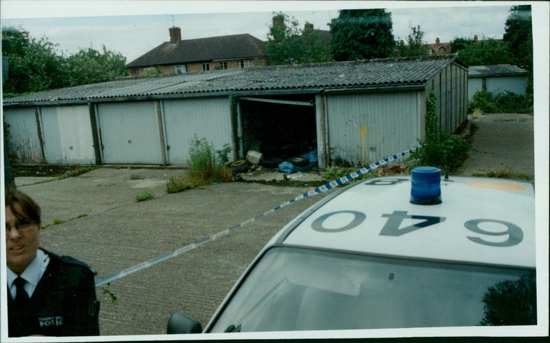 Police investigate a body found at a garage off Cumberland Road in Oxford. - Vintage Photograph