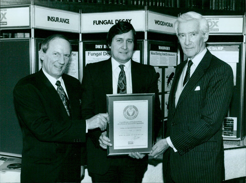 Peter Cox, from Peter Cox Preservation, receives a Certificate of Registration of a Firm of Assessed Capability from representatives of the Oxfordshire Building Society. - Vintage Photograph