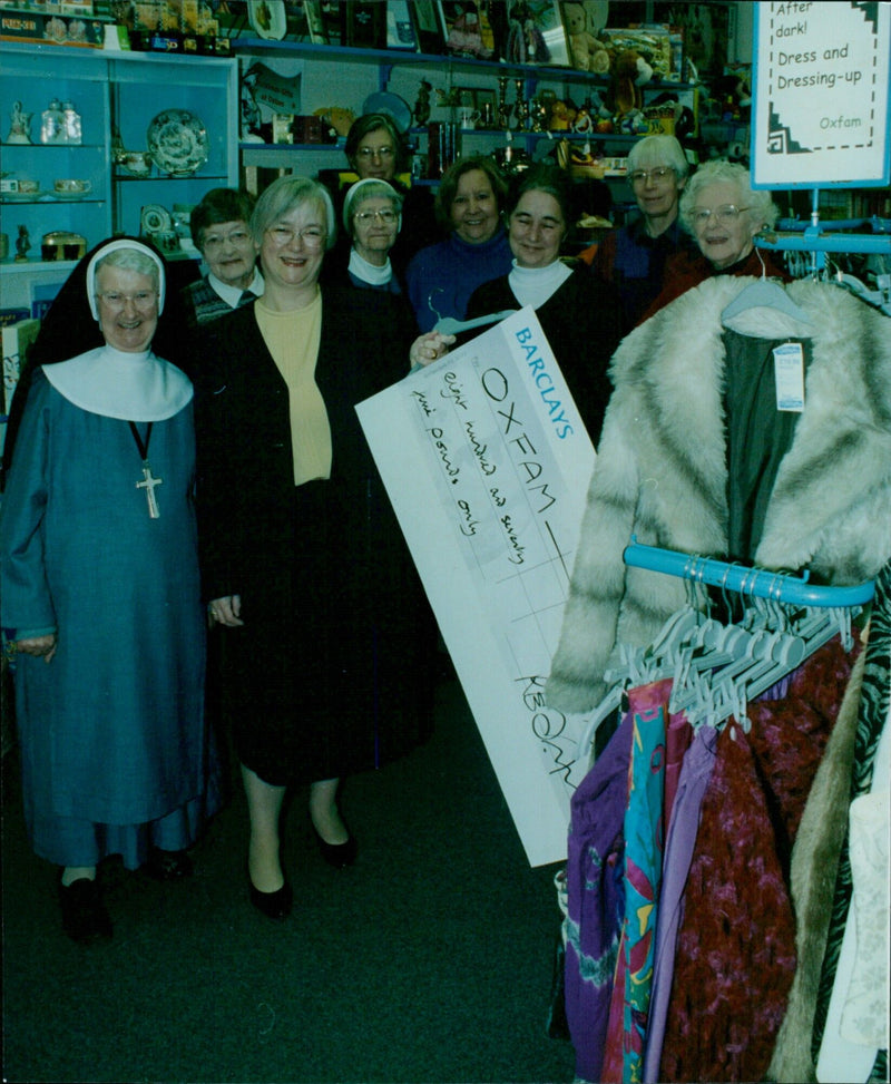 Jackie Gunn, manager of Oxfam, receives a cheque from the residents of St. Katherine House, Sister Mary Jennifer. - Vintage Photograph