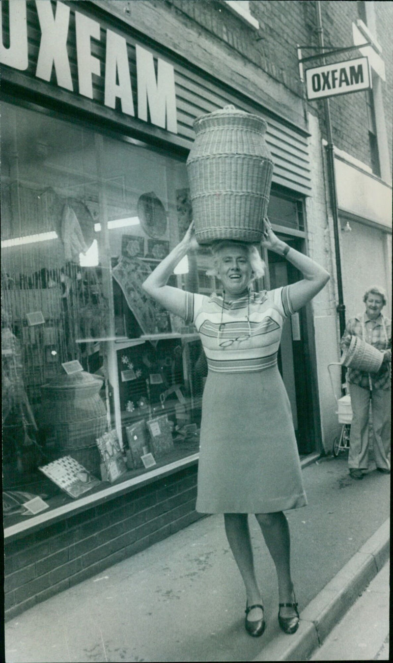 Mrs. Pamela Costella outside of an Oxfam store. - Vintage Photograph