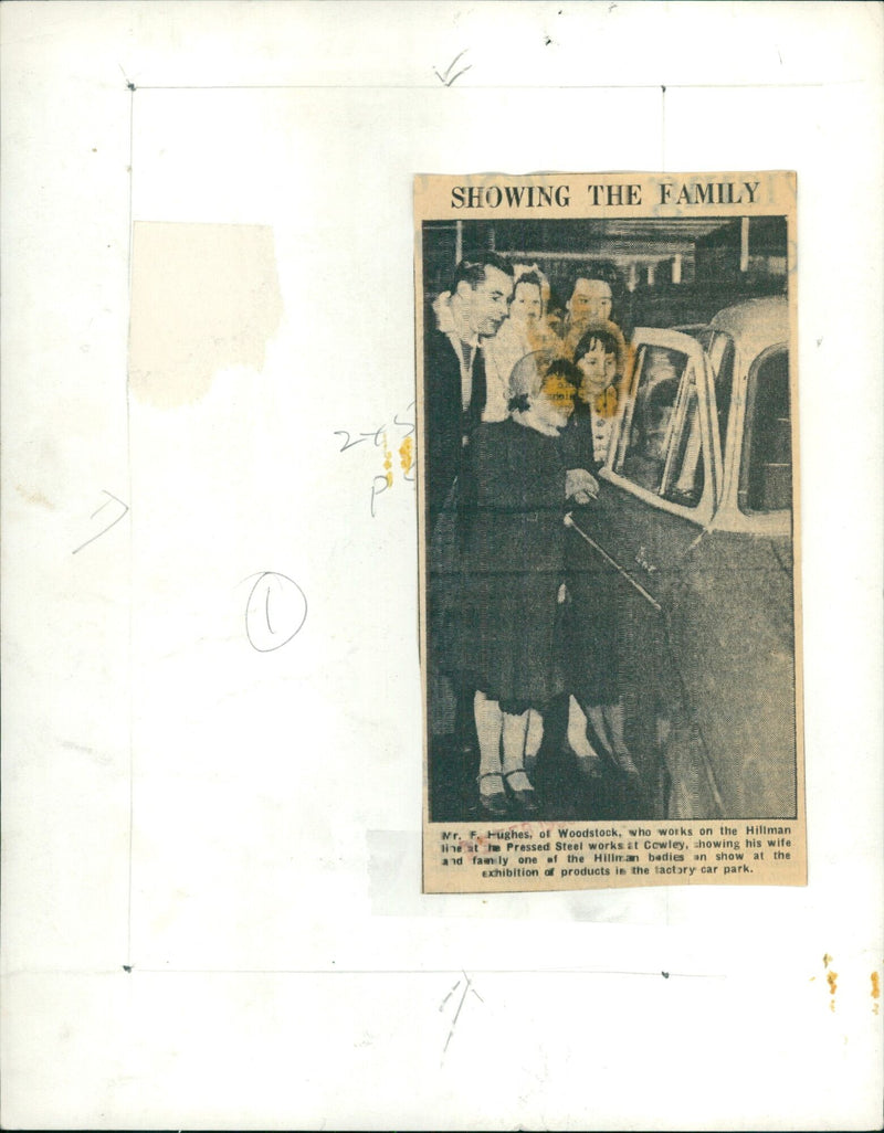 Mr. F. Hughes of Woodstock and his family viewing a Hillman bedie at the Pressed Steel works Exhibition in Cowley. - Vintage Photograph