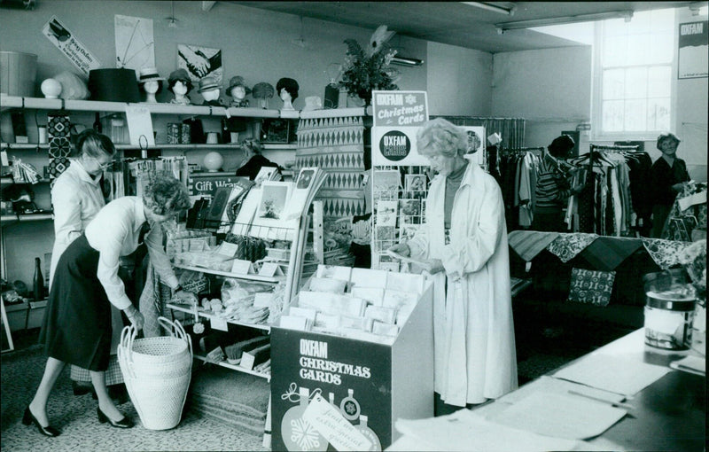 Oxfam volunteers prepare to sell Christmas cards and gift wrap in a shop. - Vintage Photograph