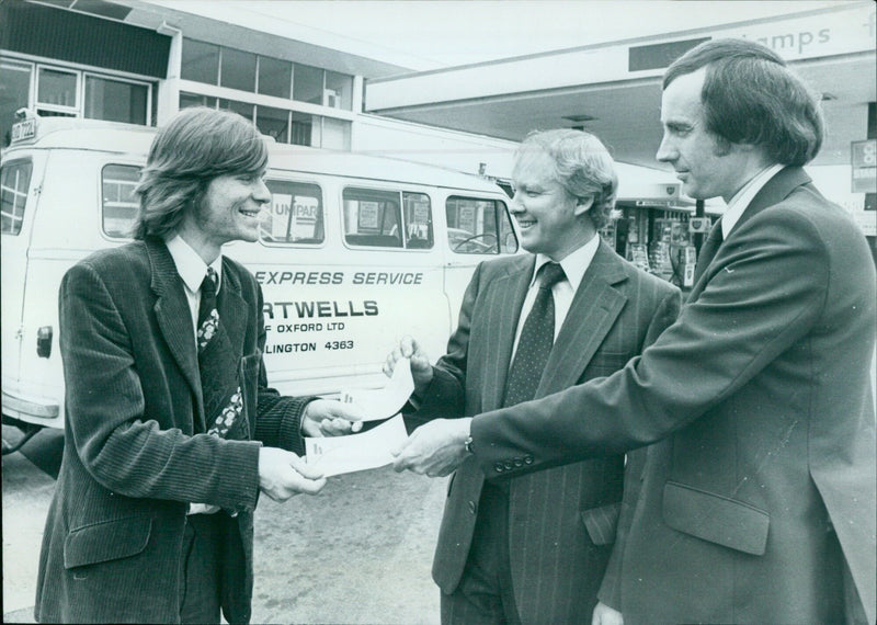 Hartwells of Oxford Ltd. presents a check to The UniPar M Express Service. - Vintage Photograph