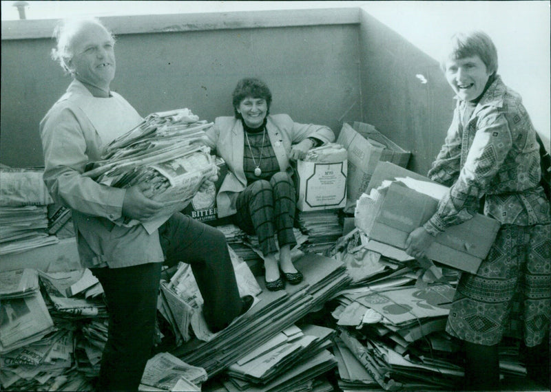 Frank Judd, Director of Oxfam, launches a weekly collection of waste paper and cardboard with the help of his wife and an Oxfam organizer. - Vintage Photograph