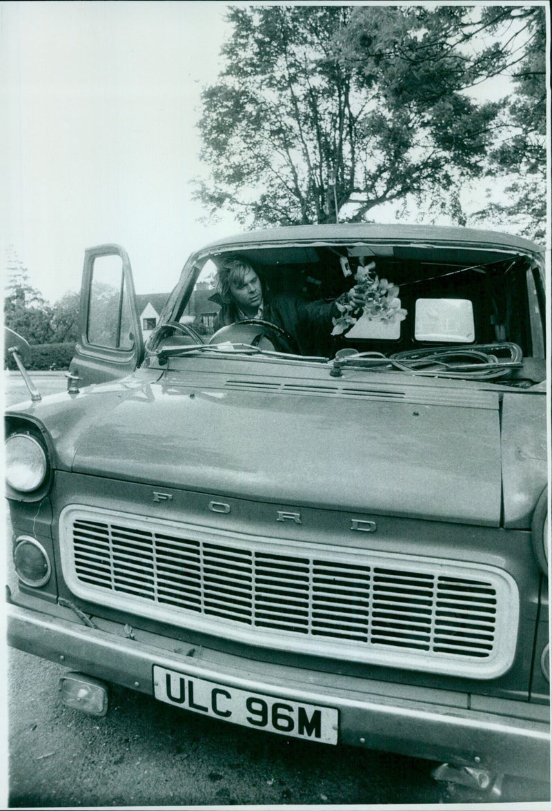 A man clears debris from the cab of his van after a branch of a tree fell in Woodstock Road, Oxford. - Vintage Photograph