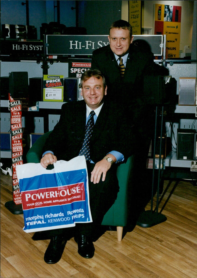 A home appliance shop advertises a "Powerhouse" special deal on Hi-Fi systems, TVs, and videos. - Vintage Photograph