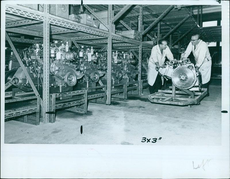 A roller truck is used to quickly remove engines in the stores department of Hartwell's Kidlington. - Vintage Photograph