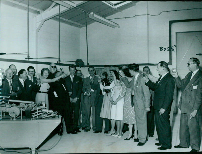 Guests celebrating the opening of Minoli and Co. Ltd. in Oxford, England. - Vintage Photograph