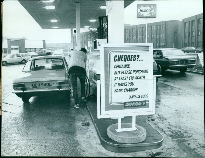 Motorists are encouraged to purchase at least £10 worth of petrol at Murco filling stations to save on bank charges. - Vintage Photograph