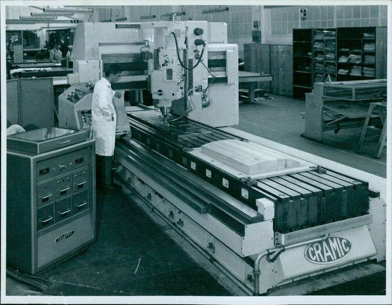 Employees of CRAMIC Pressed Steel Fisher Research & Development building work together on a project. - Vintage Photograph