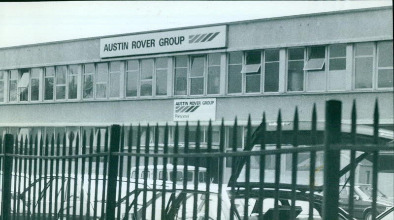 Employees of the Austin Rover Group pose outside of the Rover headquarters in Oxford, England. - Vintage Photograph