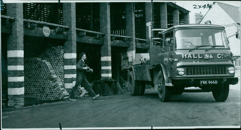 Hall and Co Ltd employees loading materials into vehicles at a new branch in Oxford. - Vintage Photograph