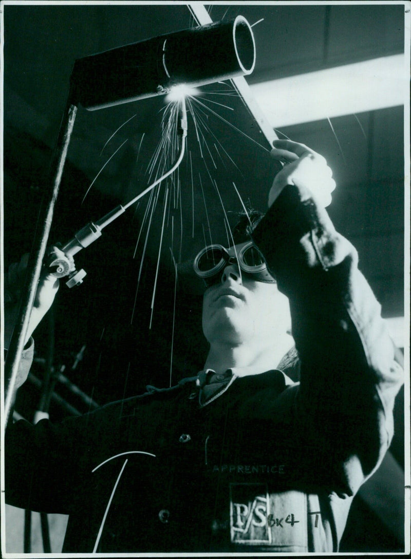 A craft apprentice completes a welding exercise. - Vintage Photograph