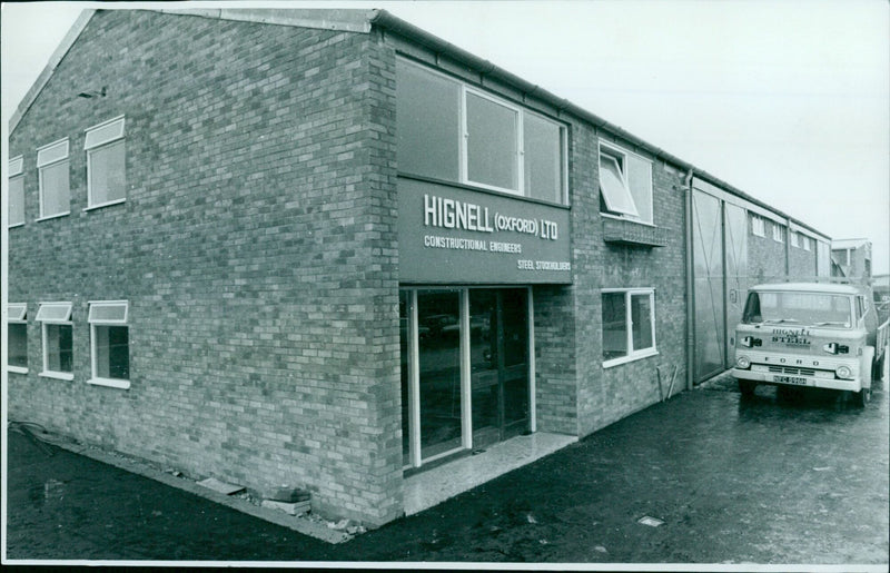 Construction workers pose in front of the exterior of Hignell's new premises. - Vintage Photograph