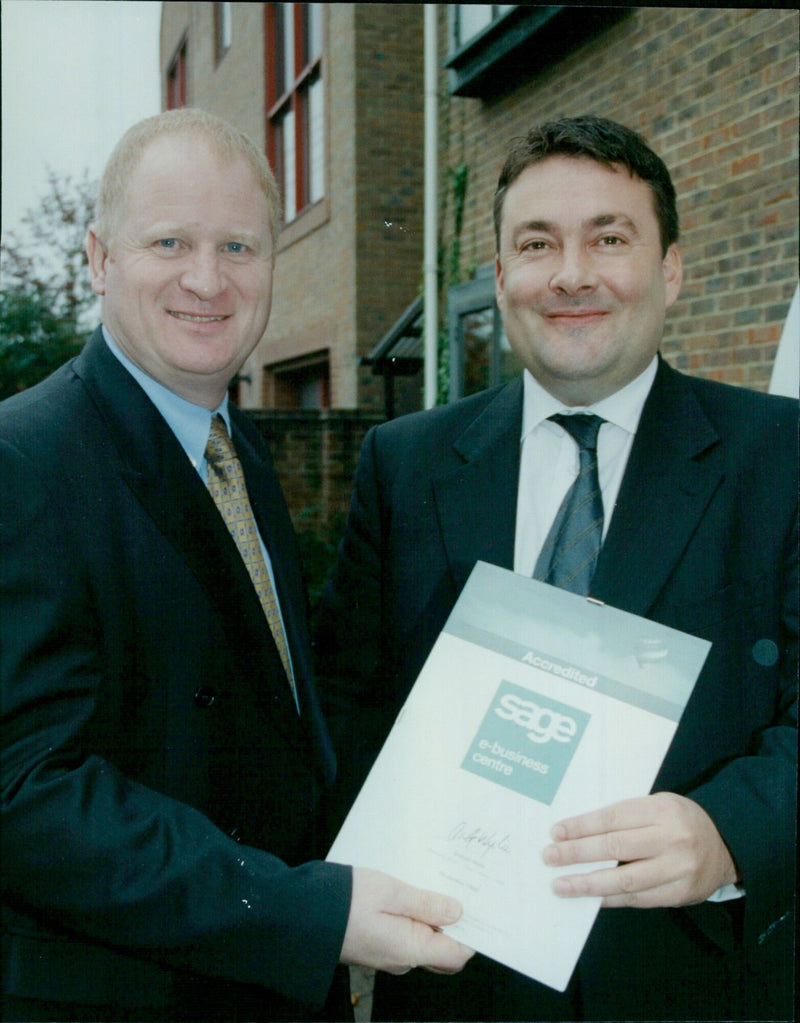 Oxford Miell Company Director Richard Clayton (left) receives an accreditation award from Sage Enterprise Solutions Business Development Manager Tony Hurst. - Vintage Photograph