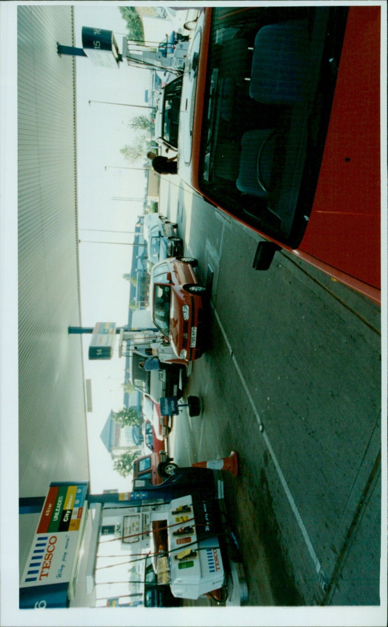 People queue up to buy fuel at a Tesco Cowley petrol station. - Vintage Photograph