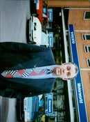 A group of cars parked at a Volvo dealership. - Vintage Photograph