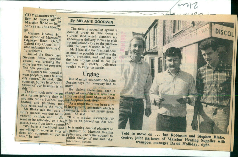 Ian Robinson and Stephen Blake, joint partners of Marston Heating Supplies, discuss the council's order to move the firm's premises. - Vintage Photograph