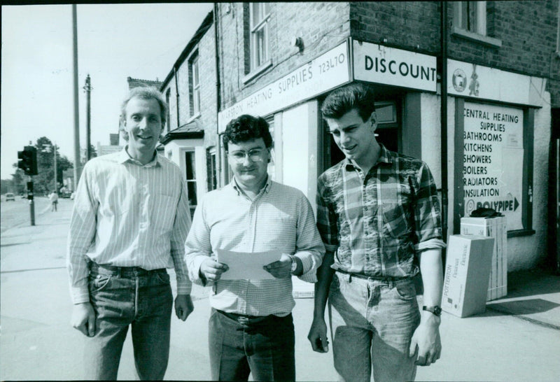 Ian Robinson and Stephen Blake, joint partners of Marston Heating Supplies, discuss the council's order to move the firm's premises. - Vintage Photograph