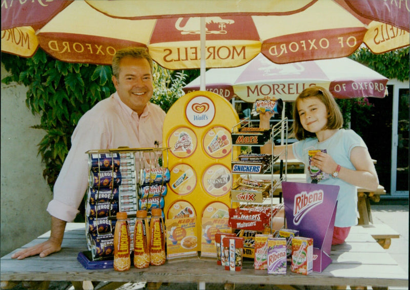 Tim Bird and his daughter Sophie hold a selection of family-friendly products that have helped Morrells reach success. - Vintage Photograph