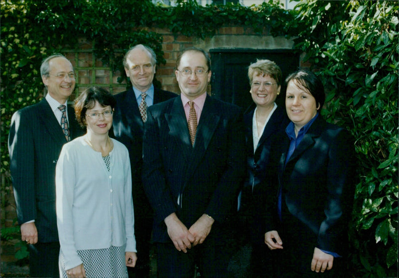 Paul Butterworth of Manches Law firm poses for a photo with members of the Manches Social Housing Group. - Vintage Photograph