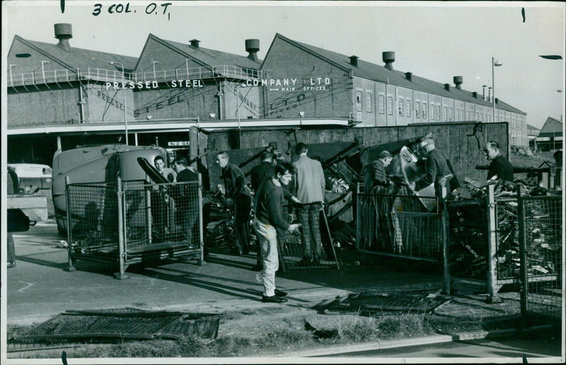 A truck spills its load at a construction site. - Vintage Photograph