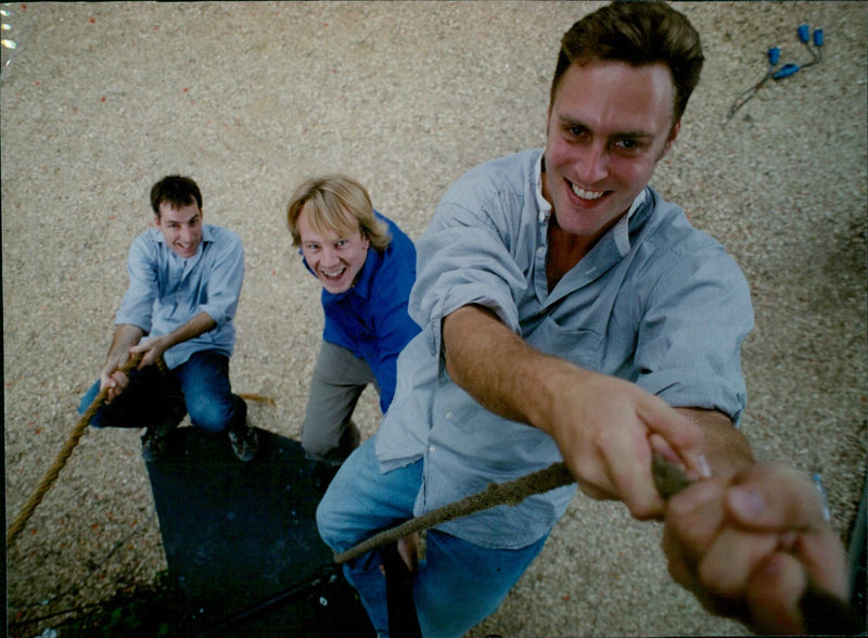 Actor Edward Marsden (center) celebrates the five-year anniversary of Drama Creation theatre company with producer David Parrish and actor Damian Davis. - Vintage Photograph