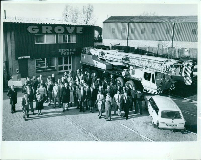 A Grove Parts Collection Service truck and a Grove Crane parked in a yard. - Vintage Photograph