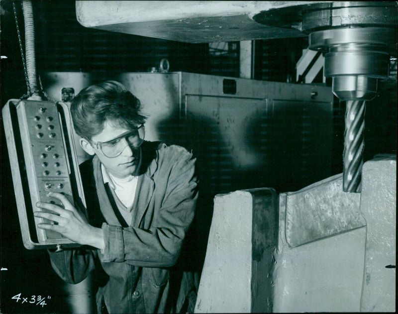 Apprentice toolmaker Brian Mills works with a large milling machine. - Vintage Photograph