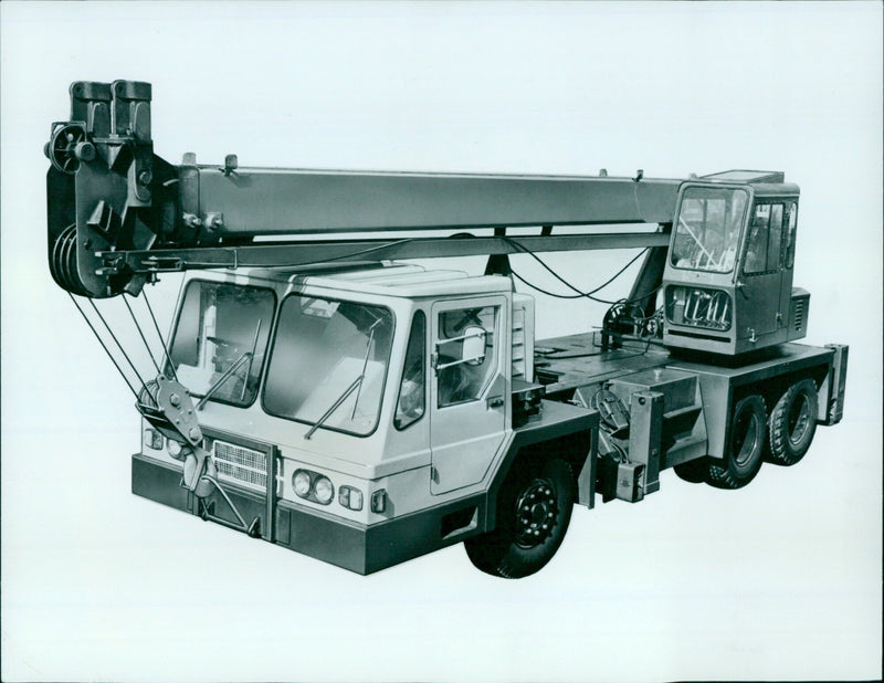 The TMS 180, a newly modernized 18-foot telescopic trunk-mounted crane, is demonstrated in the grounds of Studley Priory. - Vintage Photograph