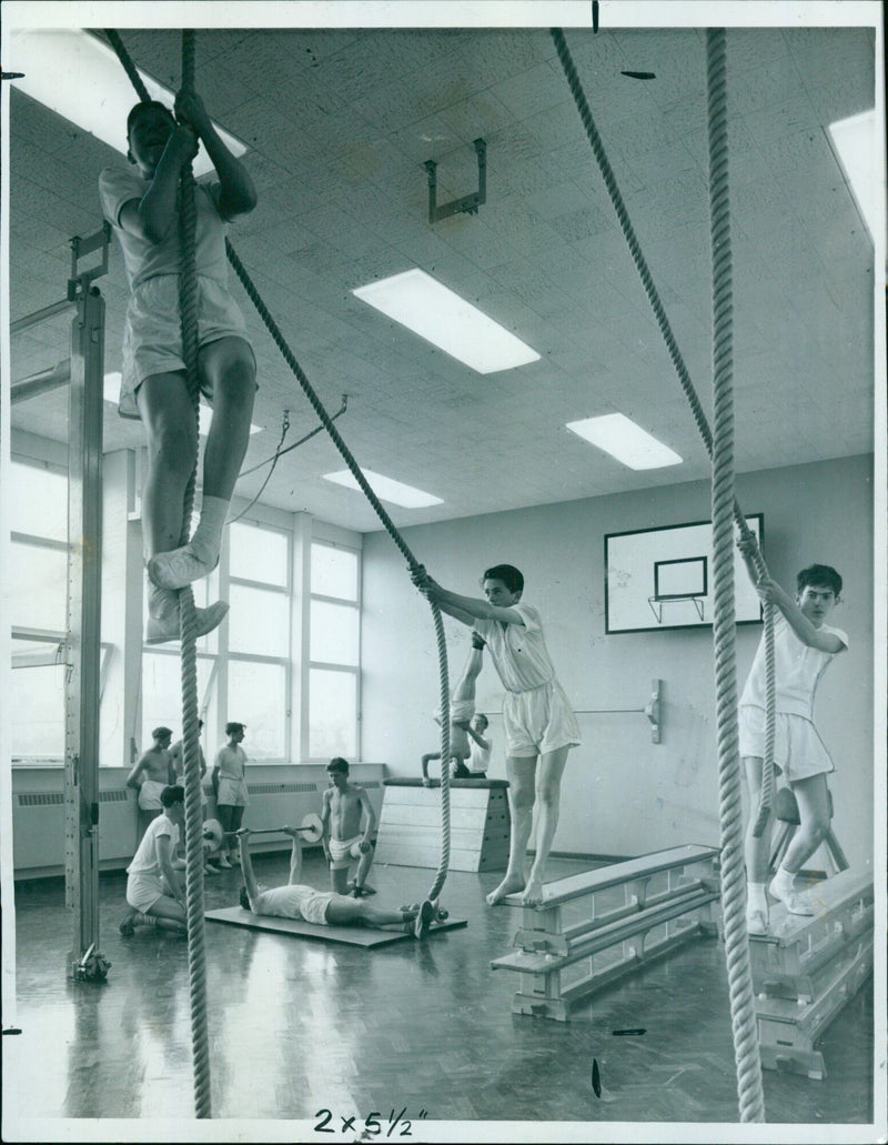 Two boys watch a Resessed Steel industrial training center. - Vintage Photograph