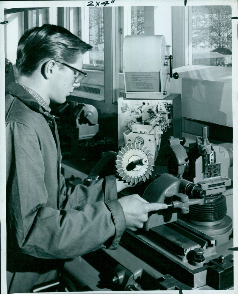 A group of students practice using the "2x4" (-10 MODEL 310 $961 AON SL in a school craft shop. - Vintage Photograph