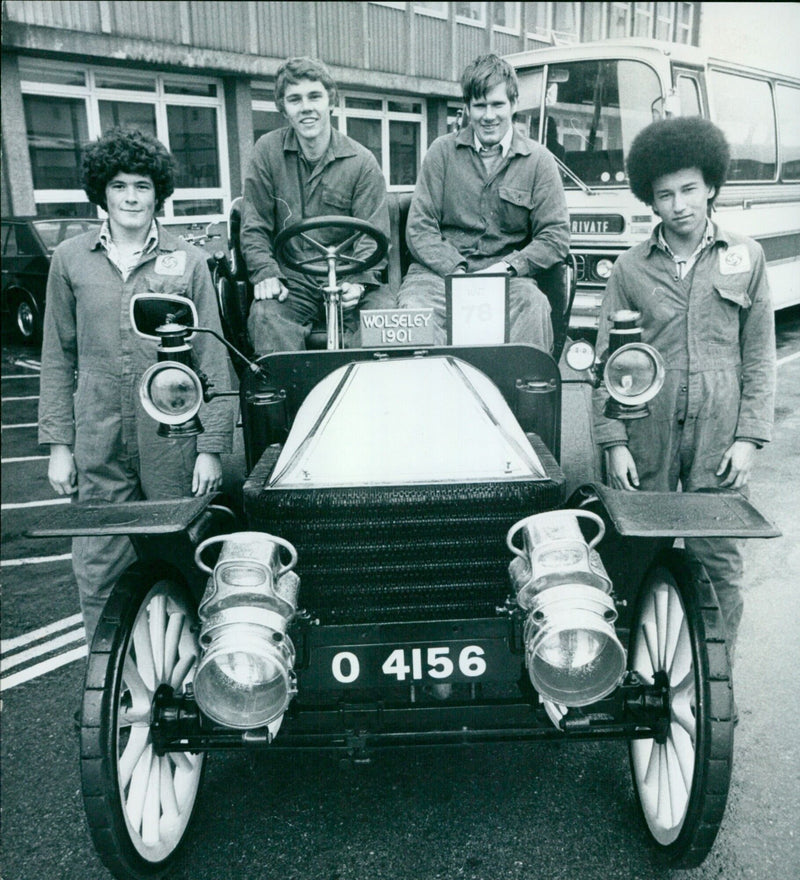 Four teenage apprentices at Cowley, England, are presented with ties after restoring a 1901 Wolseley to its original condition. - Vintage Photograph