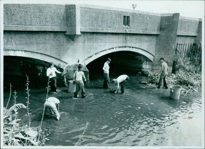 Residents in Guatemala are seen wading in floodwaters caused by heavy rains. - Vintage Photograph