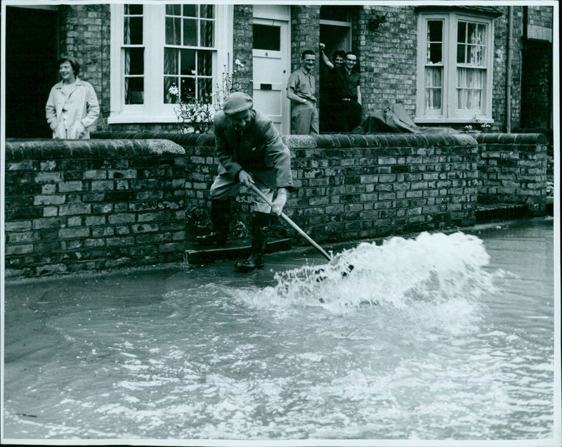 Mr. E. Thompson attempts to prevent floodwater from entering his home in Middletown. - Vintage Photograph