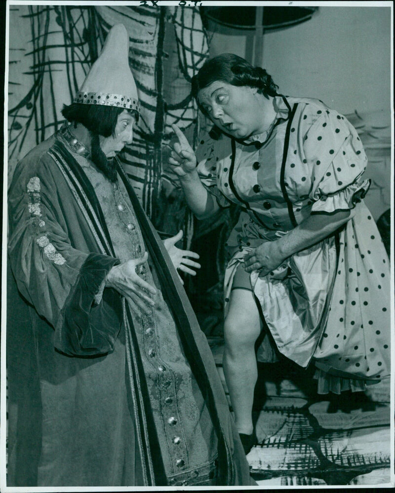 Widow Twanky gives Abanazer the brush off in a pantomime performance. - Vintage Photograph