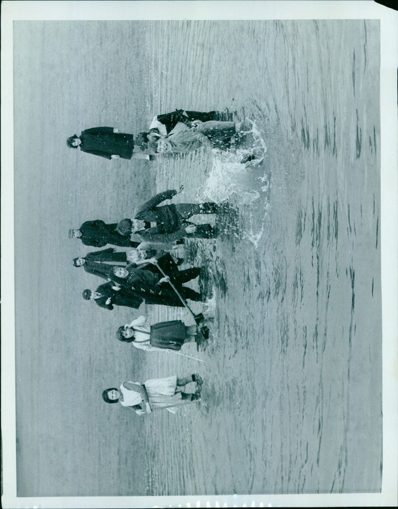 Residents of Ell 19 are seen wading through floodwaters in a park on November 2, 1960. - Vintage Photograph