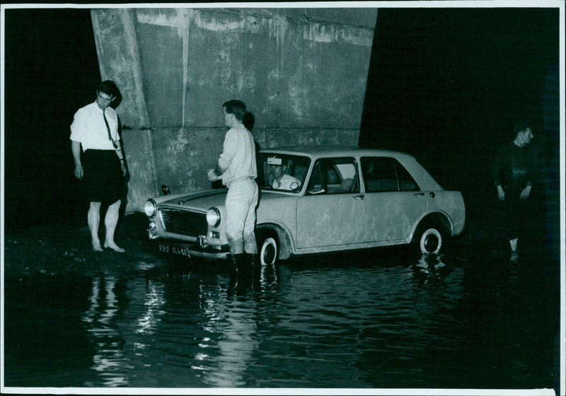 Cars stranded in flood waters under a flyover bridge on the Eastern Bypass. - Vintage Photograph