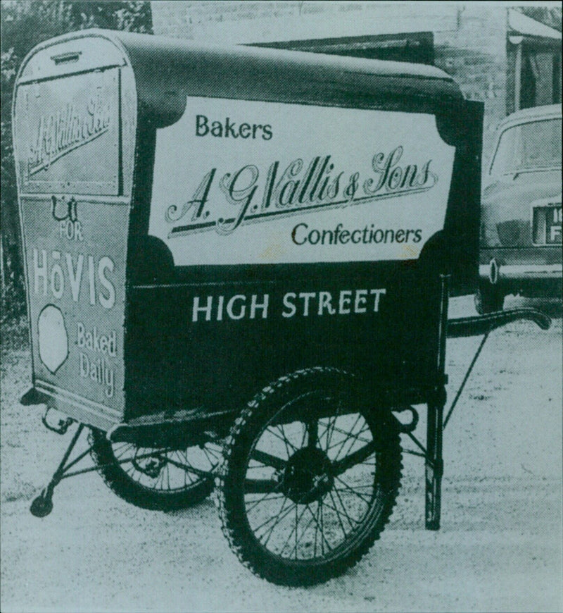 An iconic view of the High Street in Headington, Oxford, with its bakery, Vallis & Sons Confectioners, captured by photographers Christine Bloxham and Susanna Shatford. - Vintage Photograph