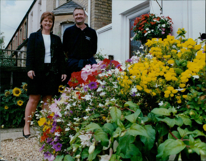 Karen and Steve Drewett, owners of Cowley Crescent Road garage, celebrate their win of the best small business outside display in the Oxford in Bloom competition. - Vintage Photograph