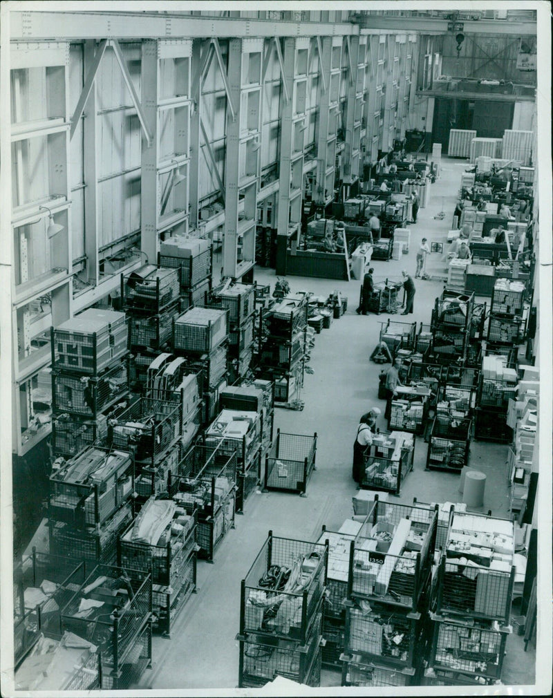 A supply truck is seen delivering materials to the Overseas B.M.C. Cowley 94756 warehouse. - Vintage Photograph