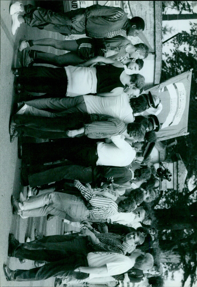 A crowd of people queuing outside a store during the COVID-19 pandemic. - Vintage Photograph