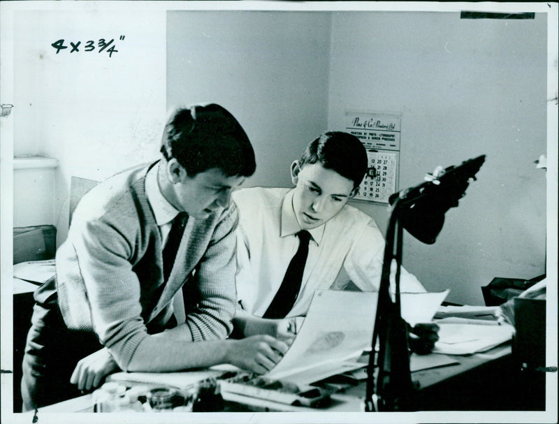 Michael Wade (right) and Adrian Hodgkins (left) pose for a photo after Wade was promoted to art director at Pergamon Press. - Vintage Photograph