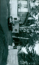 A crowd of people gather in a town square. - Vintage Photograph